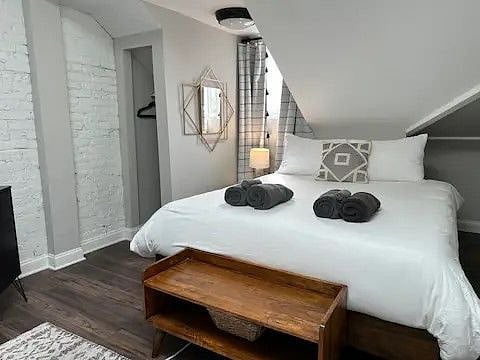 The second bedroom has a Queen bed and a 42" smart TV. The ceilings are low by the bed, but the rest of the room has nice ceiling height.