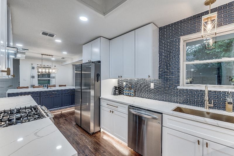 Freshly remodeled kitchen, stone counters, stainless steel appliances, gas stove, dishwasher, refrigerator, ventahood, under-counter lighting.