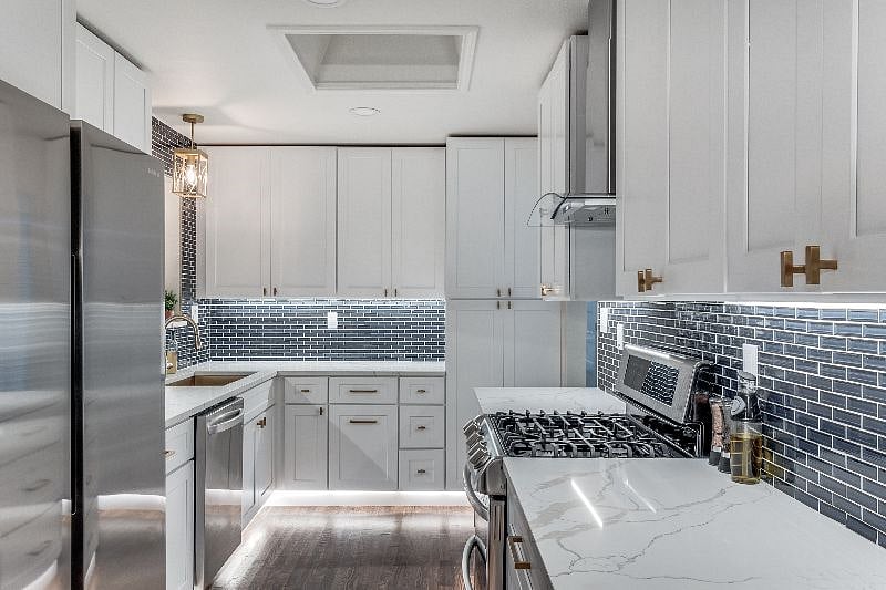 Freshly remodeled kitchen, stone counters, stainless steel appliances, gas stove, dishwasher, refrigerator, ventahood, under-counter lighting.