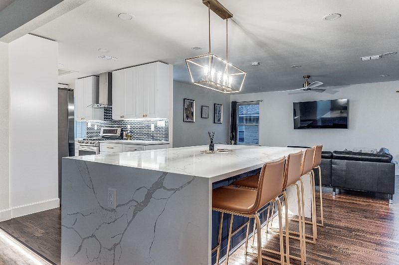 Large stone island connected to kitchen.