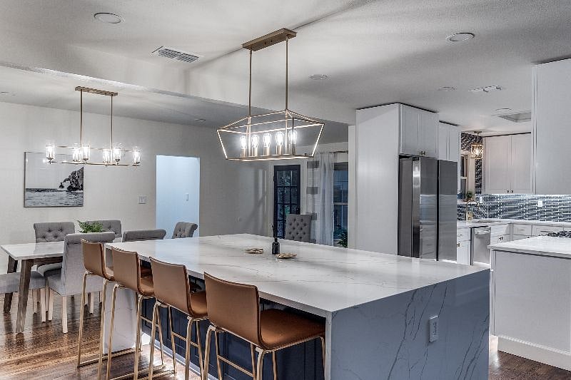 Large stone island connected connected to dining room and kitchen.