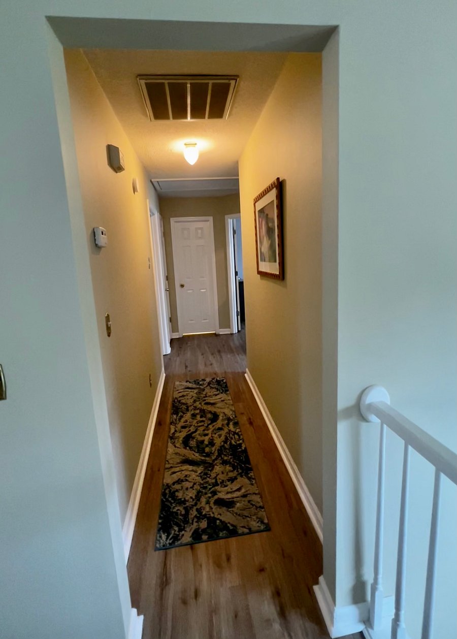 Hallway to master bathroom and two guest rooms