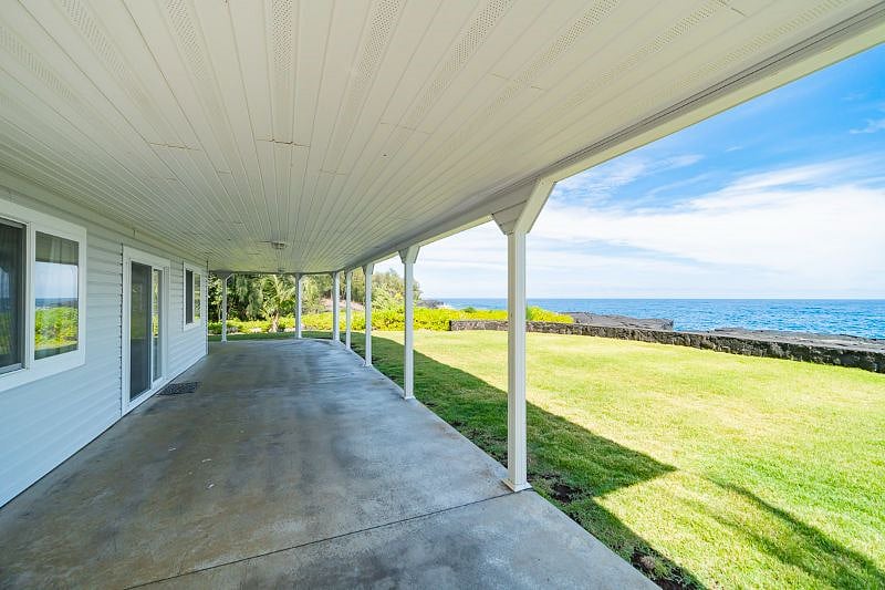 Deck surrounds three sides of home