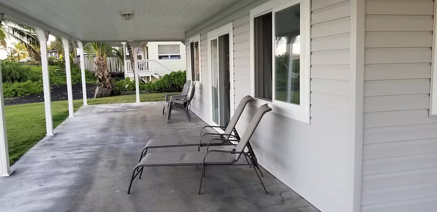 Deck surrounds three sides of home