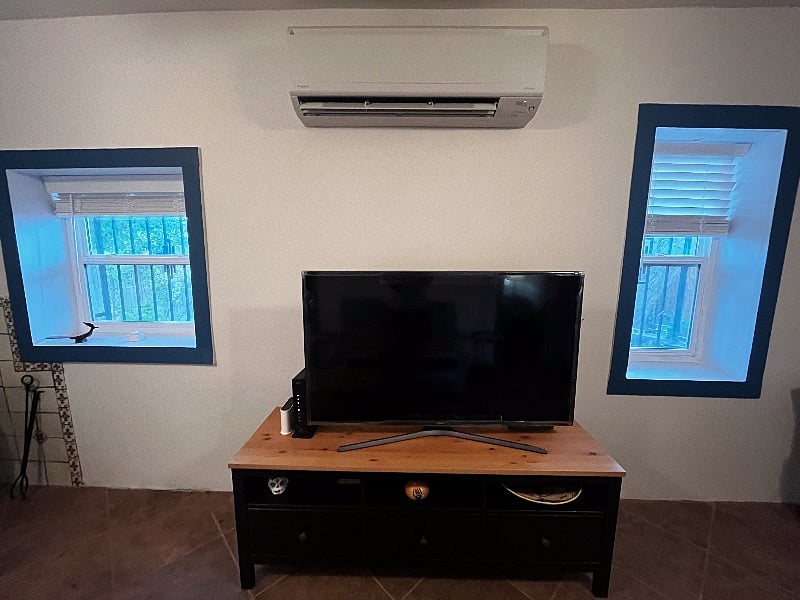 Living room, big windows that are one foot deep of adobe walls, the smart tv and mini-split heat/air conditioning make this room very relaxing and comfortable.