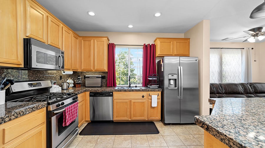 Open kitchen with mountain views and filtered water with ice maker in refrigerator/freezer.