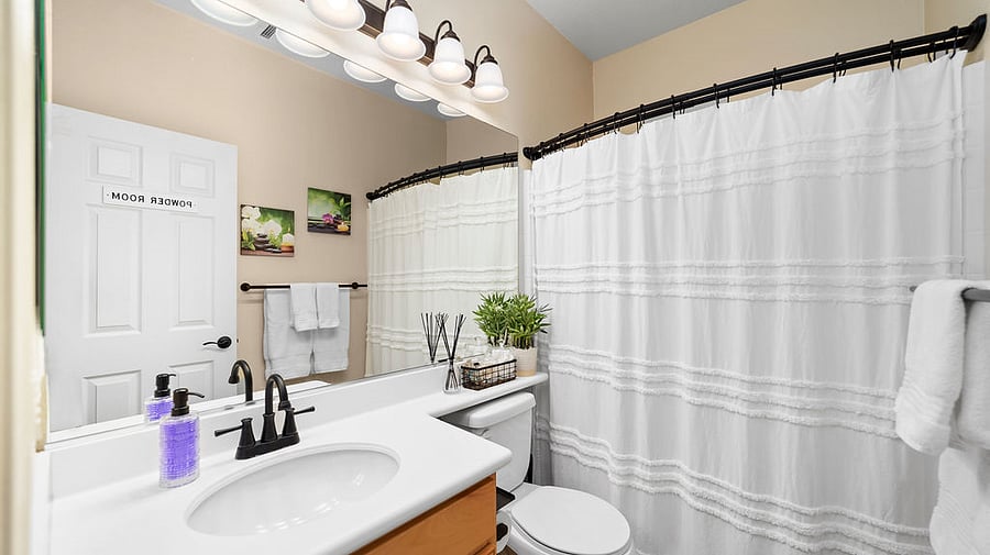 Hallway and guest bathroom with Q-tips and cotton balls.  Exhaust fan on timer switch for automatic shut off.