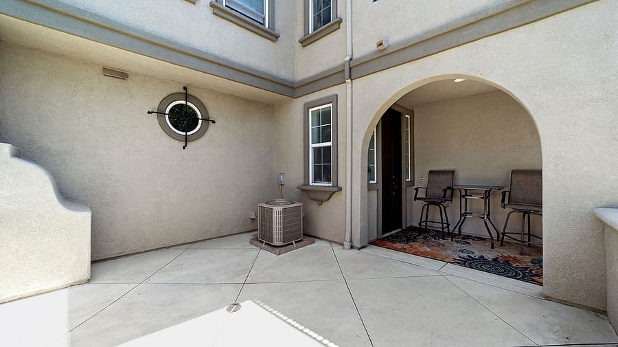 Lower, private corner patio and front door.  Packages received here.