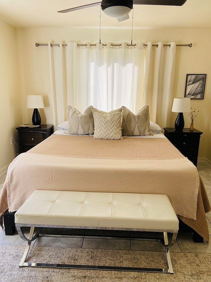 Primary Suite with luxury mattress, high thread count sheets, and sitting area.