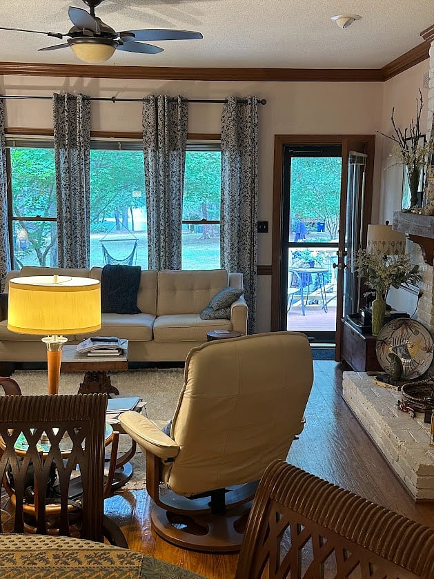 Living area with door to back deck and view of the pond.