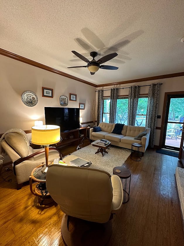 Living area with view of pond and opening onto back deck.