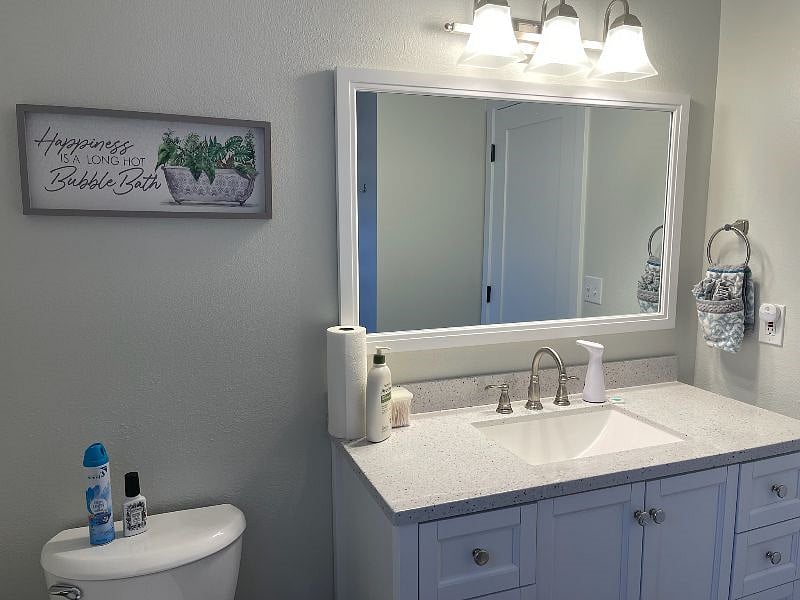 GUEST BATHROOM SINGLE VANITY LOTS OF STORAGE, SHOWER OVER TUB