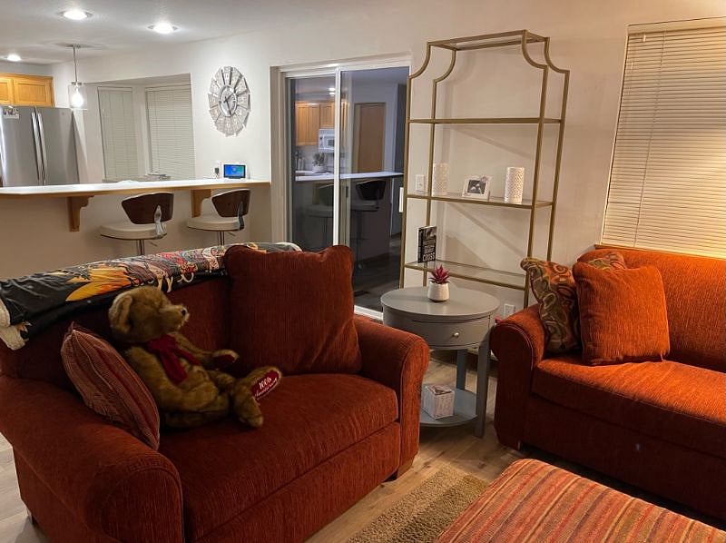 FAMILY ROOM & SLIDING GLASS DOOR TO PATIO
SHELF UNIT WITH GAMES