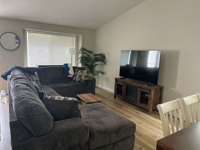 LIVING ROOM-NEW FURNISHING: SAMSUNG SMART TV, CREDENZA W/ELECTRIC FIREPLACE.