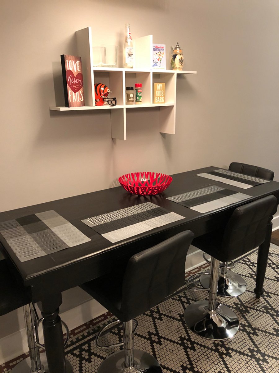 Kitchen table has four barstool height chairs.