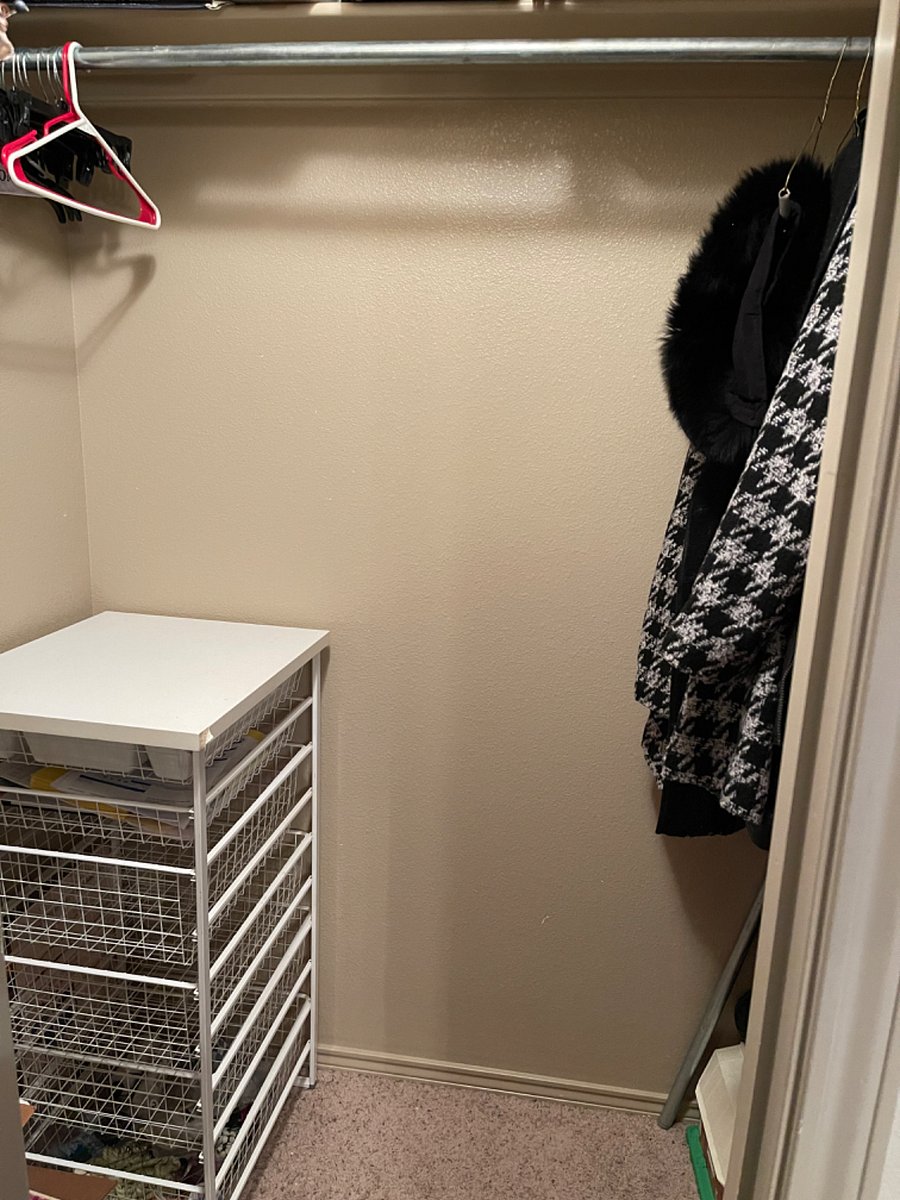 Walk-in closet in one guest bedroom