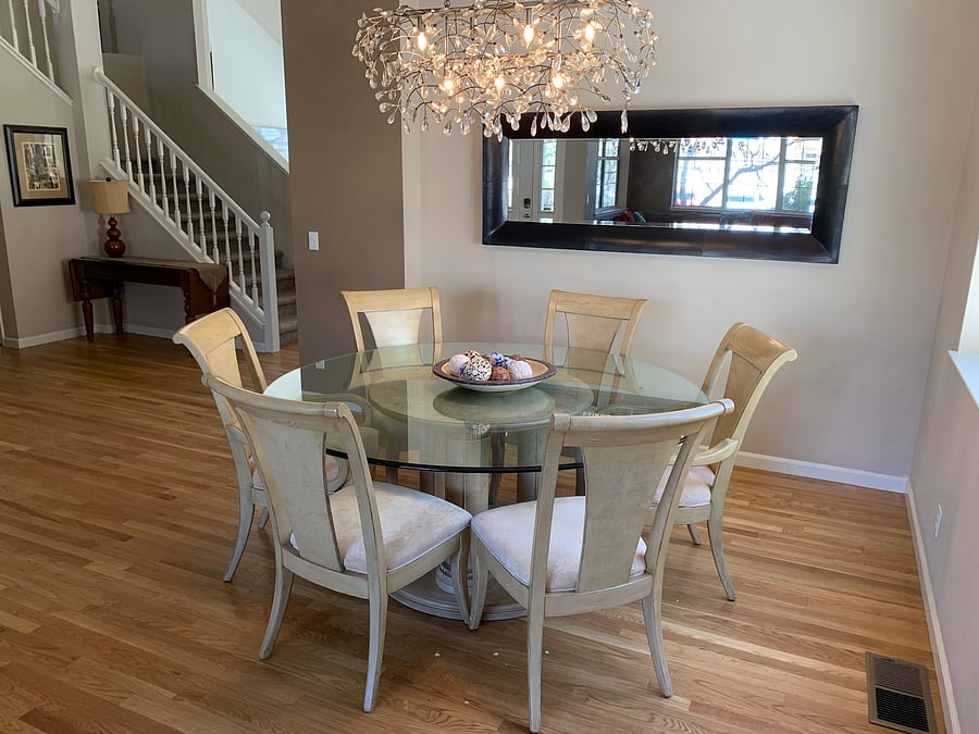 Dining table seats six and showcases a designer chandelier.