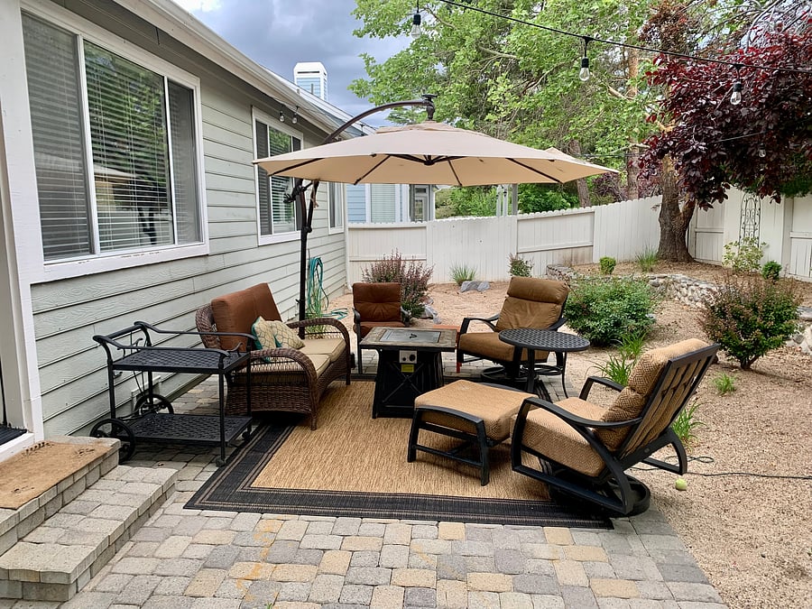 Backyard is fenced in and includes seating for 6. Umbrella, rug, firepit, grill and lights make it a great romantic spot at night.