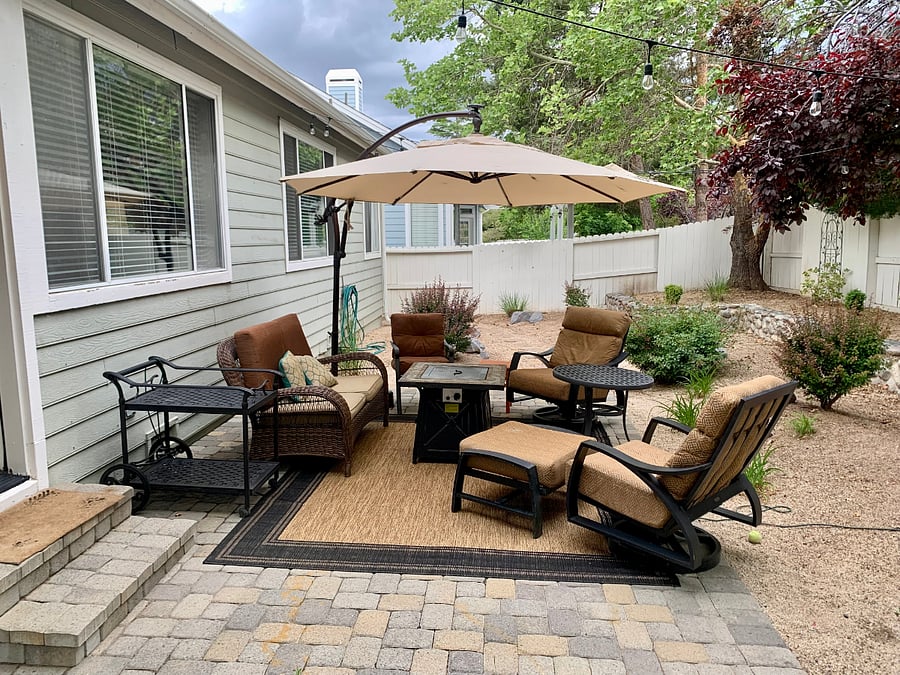 Fenced in backyard with grill