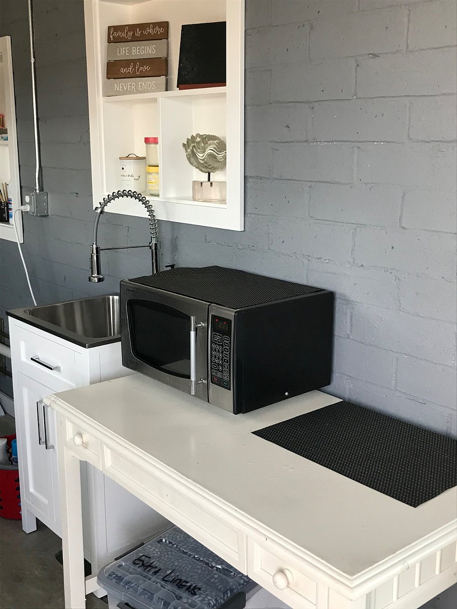 Utility sink in laundry room completely remodeled with butcher block counter top and coffee station.