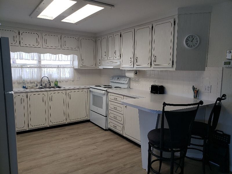 Peninsula provides extra countertop space and a cozy seating area for two.