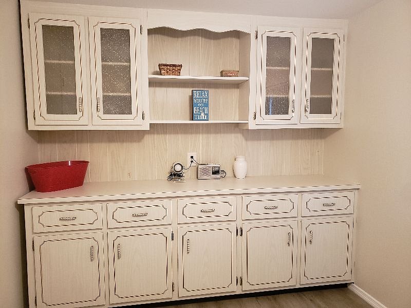 Built in hutch holds fun kitchen supplies like fondue set, George Foreman grill, panini maker, seafood utensils and more. And, great for storage space!