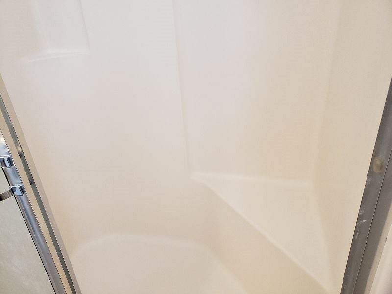 Primary Bathroom shower has a nice sized bench for sitting if needed for safety, shaving, or just relaxing.