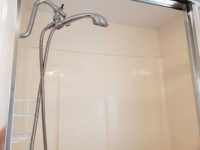Shower wand with multiple spray settings and an additional hard spray spigot in Primary Bathroom shower.
