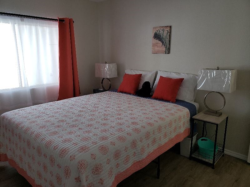 Guest Bedroom with Queen bed, 2 large closets and blackout curtains.