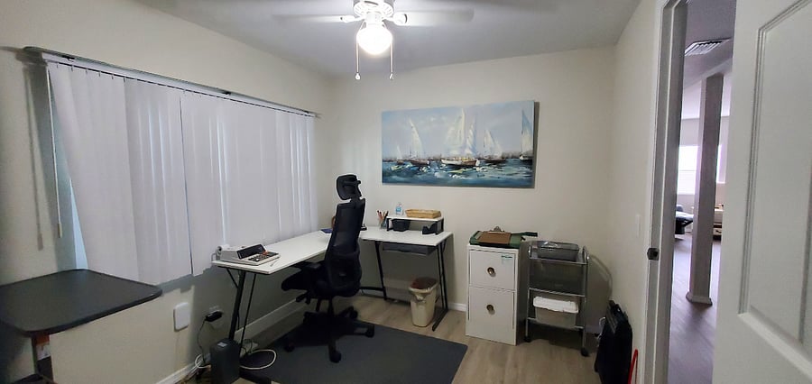 Spacious office with L-shaped desk in private room and closing door