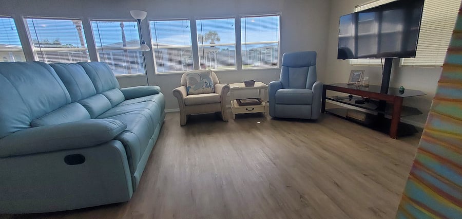 Spacious living room complete with lots of natural light from front bank of 6 windows