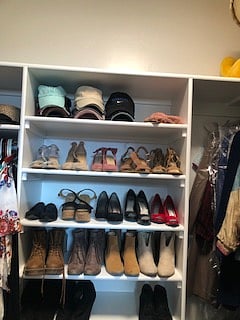 Large master suite walk-in closet with storage.