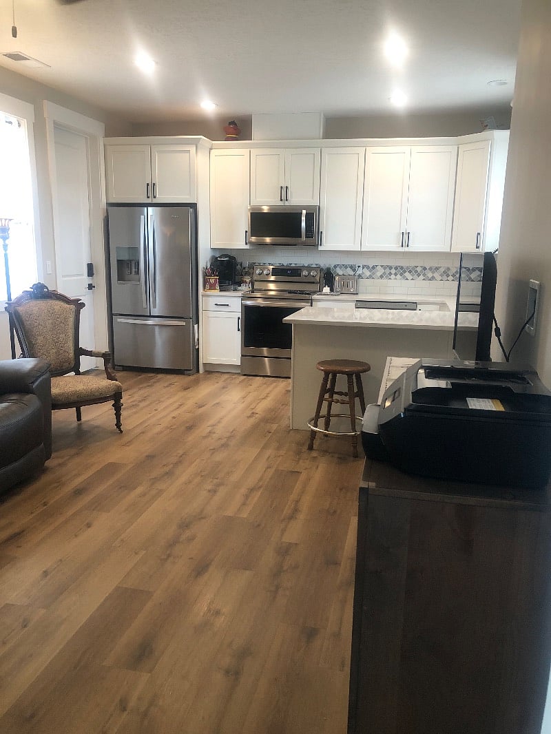 Your full kitchen, with stainless steel appliances of french door refrigerator, glass top range, microwave, dishwasher, and large sink with counter tops of quartz and also on your bar area.
