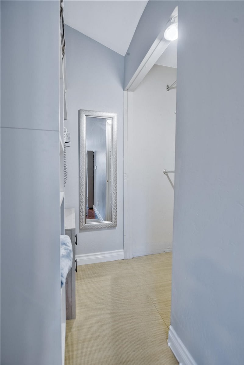 Closet with shelving and full length mirror.