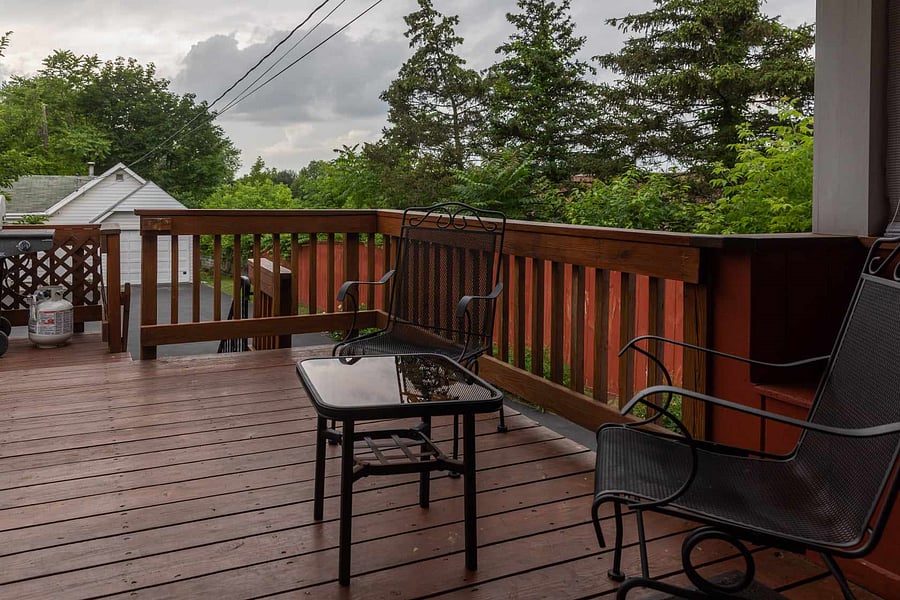 Back deck with propane grill and seating.
