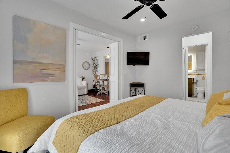 Cable television, ceiling fan and black out curtains in bedroom.