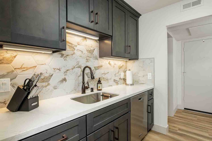 Beautiful under cabinet lighting and Quarts countertops with plenty of space.