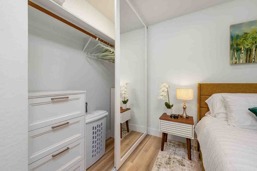 Customized closet with roll away hamper.