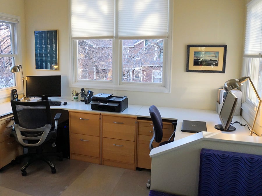 Two desk office with vaulted ceiling and work table on other side of the room