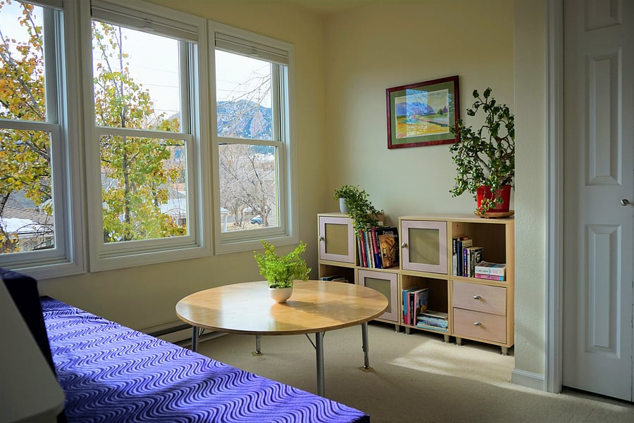 Office alcove work space with couch and view of the Flatirons in the winter