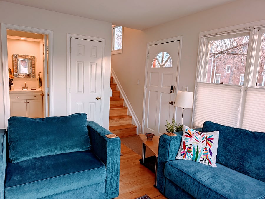 Front door entry from porch, stairs leading to second floor. Bathroom off of living room
