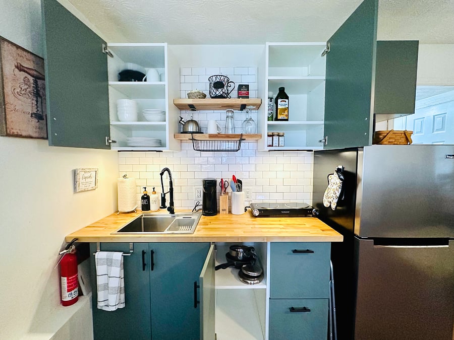 This is your fully stocked kitchen - pots & pans, plates/bowls, utensils, cutting board, cooking utensils, oil & all the basic spices. Appliances include: fridge, 2 burner hotplate, air fryer/micro combo, Keurig (with k cups!). Just like home! 