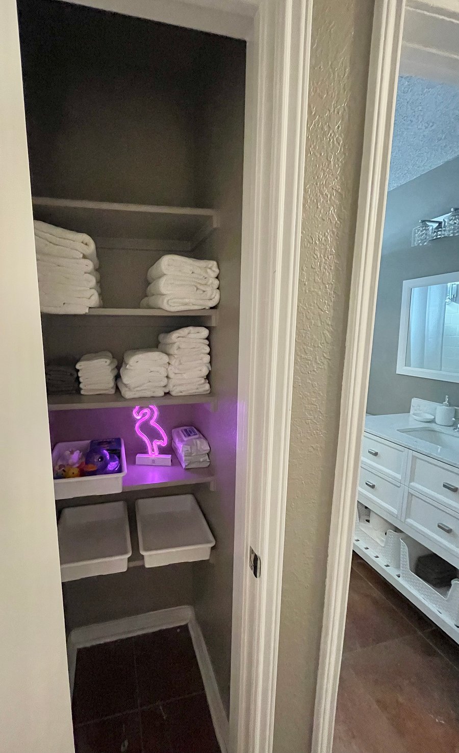 Towels and tub toys in linen closet