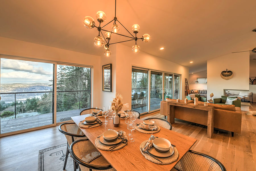 Dining area with sweeping views of Mt Hood and Williamette River, city lights.