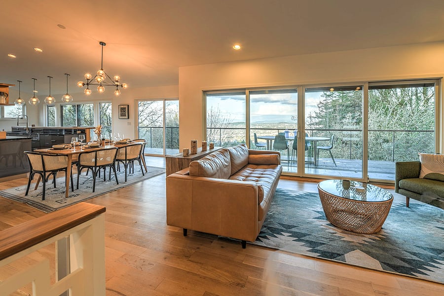 Open and spacious great room with sliding glass doors and expansive city, mountain and river views.