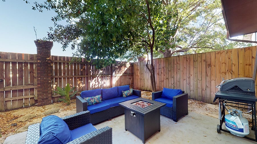 Fenced in Backyard Patio with propane firepit and pull down movie screen
