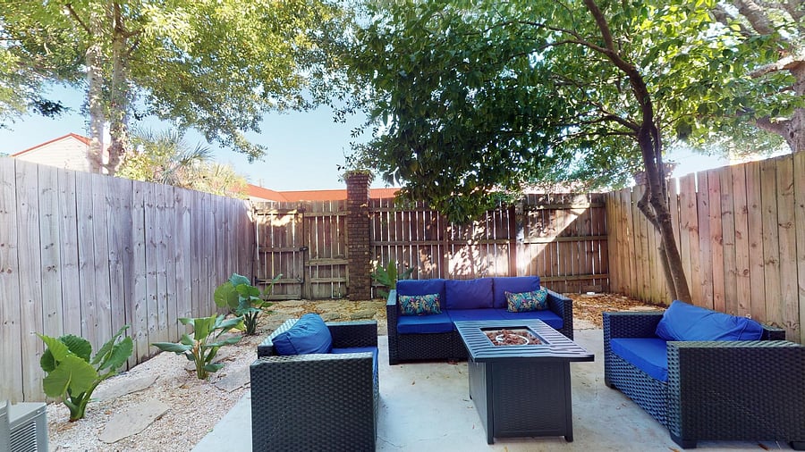 Fenced in Backyard Patio with propane firepit and pull down movie screen