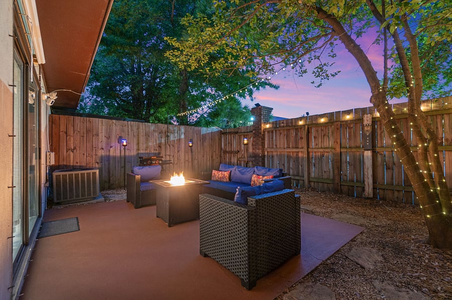 Fenced in Backyard Patio with propane firepit and pull down movie screen