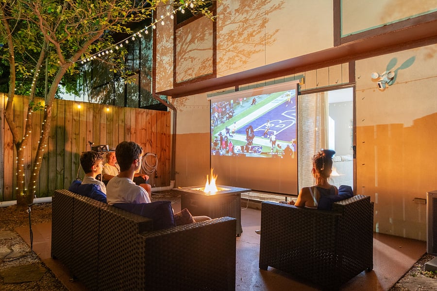 Fenced in Backyard Patio with propane firepit and pull down movie screen