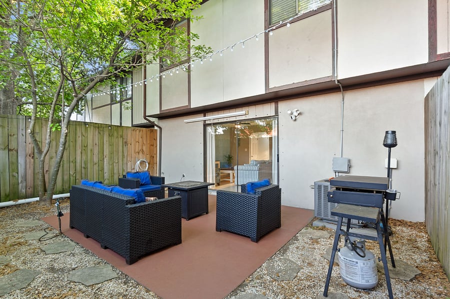 Fenced in Backyard Patio with propane firepit and pull down movie screen